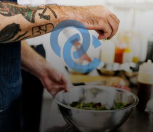 Chef Mixing Salad with OC Logo